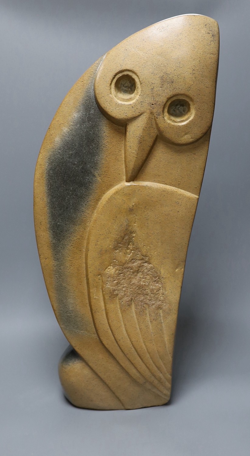 A Zimbabwean carved and polished stone figure of a stylised winged bird, with a long neck. 64cm